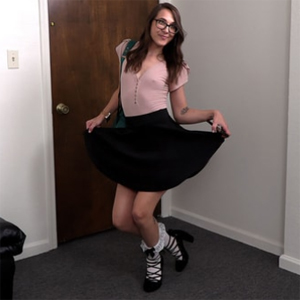 Hairy girl in glasses lifts her skirt